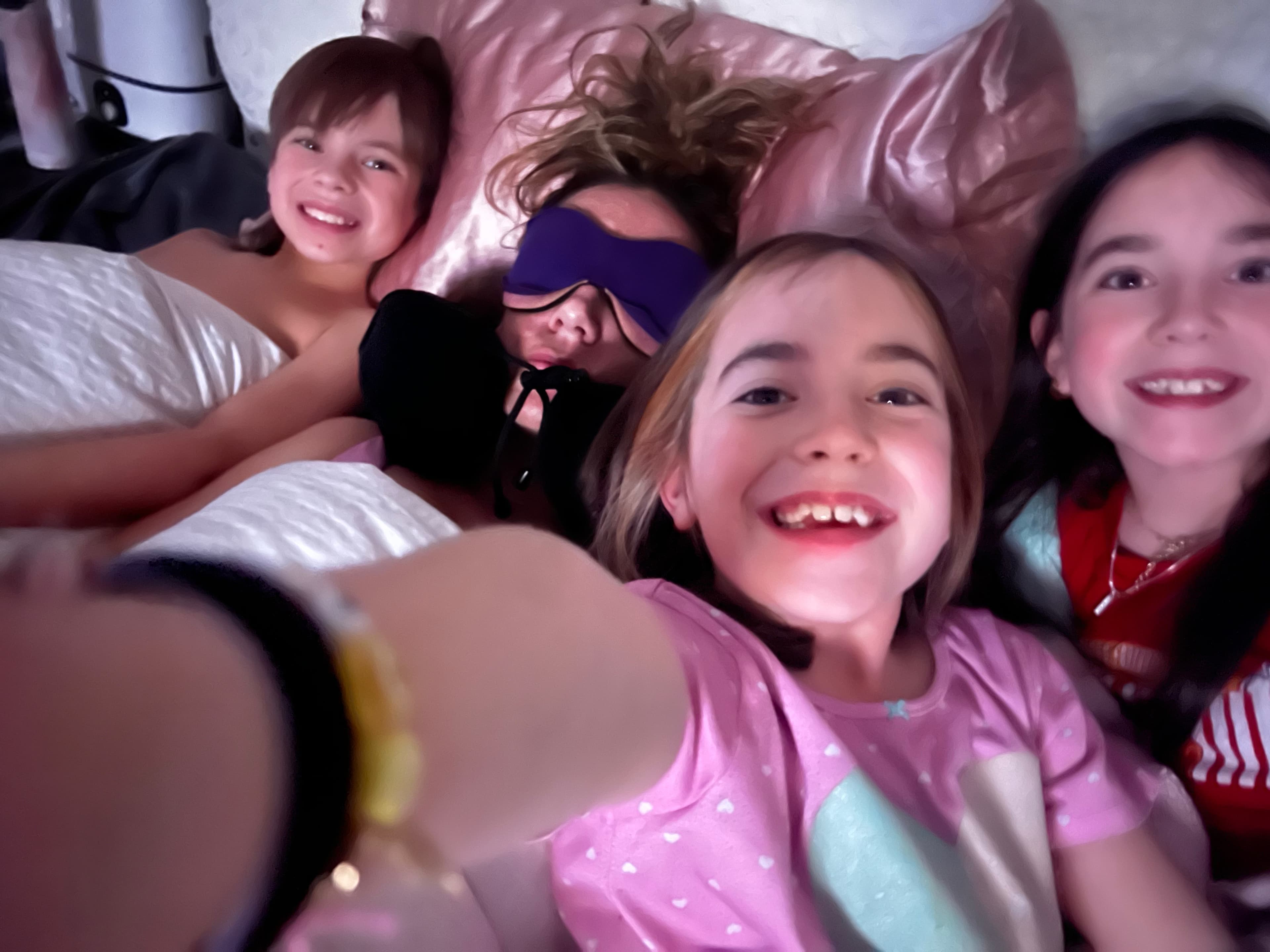 Meg Miller snuggling with her children in bed
