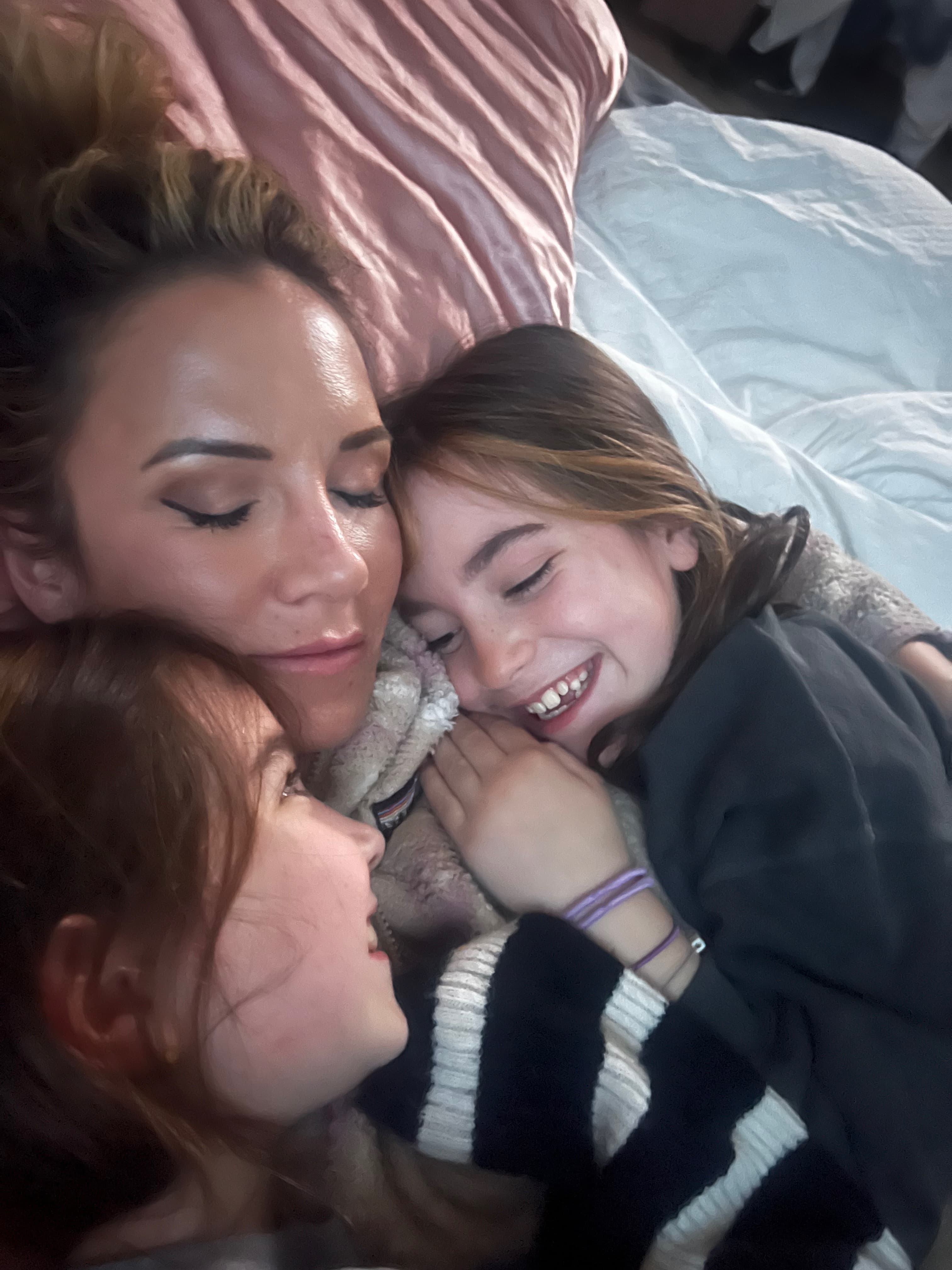 Meg Miller snuggling with her twins